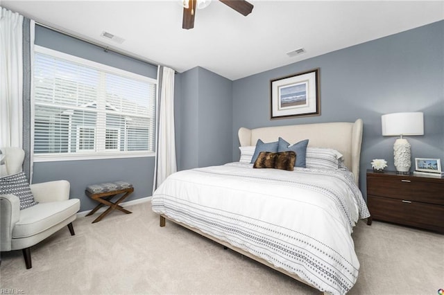 carpeted bedroom featuring visible vents, a ceiling fan, and baseboards