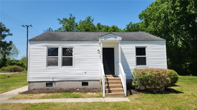 bungalow-style house featuring crawl space and a front lawn