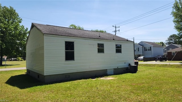 view of side of home featuring central AC, a yard, and crawl space