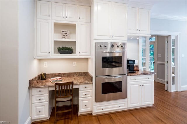 1263 Murphys Mill Rd, Suffolk, VA 23434 - kitchen with built in study area, stone countertops, double oven, and light wood-style flooring