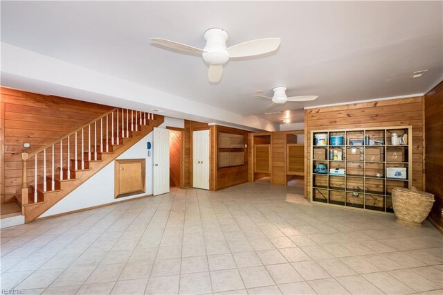 1263 Murphys Mill Rd, Suffolk, VA 23434 - unfurnished living room with a ceiling fan, wood walls, and stairway