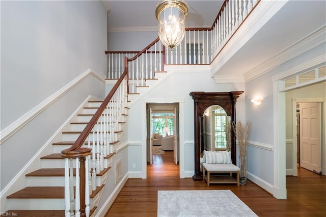 1263 Murphys Mill Rd, Suffolk, VA 23434 - stairway featuring a high ceiling, a chandelier, wood finished floors, visible vents, and ornamental molding
