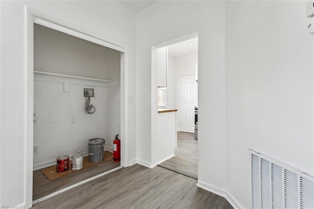 laundry room with visible vents, laundry area, wood finished floors, baseboards, and washer hookup