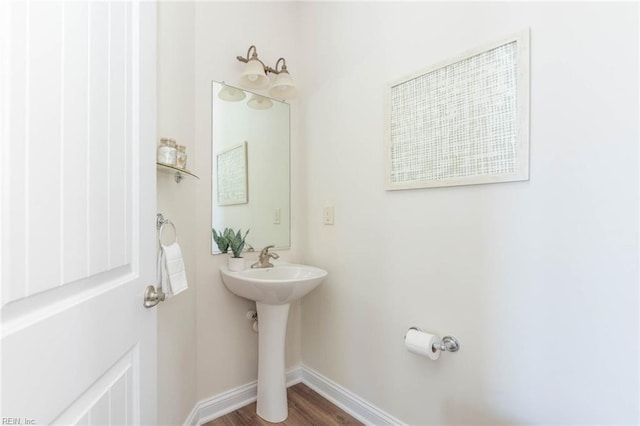 bathroom featuring baseboards and wood finished floors