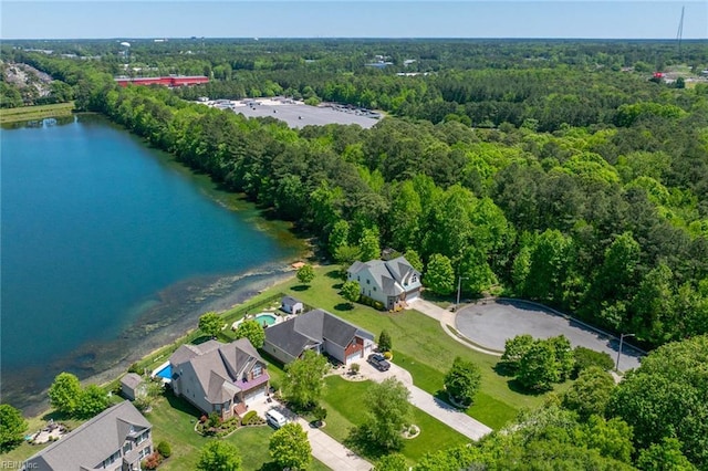 birds eye view of property featuring a water view and a wooded view