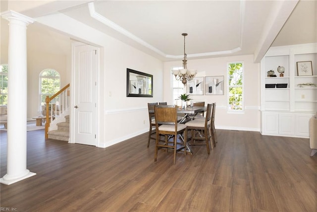 dining room featuring stairway, a tray ceiling, dark wood finished floors, and a chandelier