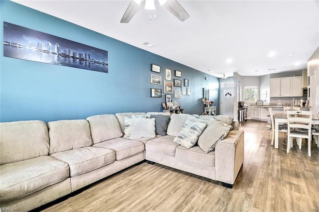 221 Kenny Ln, Smithfield, VA 23430 - living area featuring light wood-style floors, ceiling fan, and visible vents