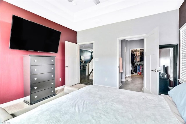bedroom featuring baseboards, carpet, a walk in closet, and a closet