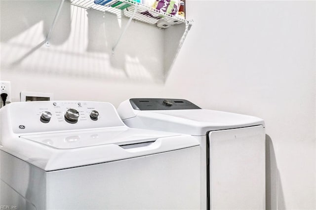 laundry area featuring separate washer and dryer and laundry area