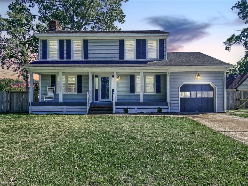 view of front facade with fence, a garage, a chimney, covered porch, and driveway