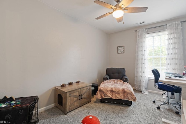 home office with ceiling fan, visible vents, vaulted ceiling, baseboards, and light carpet