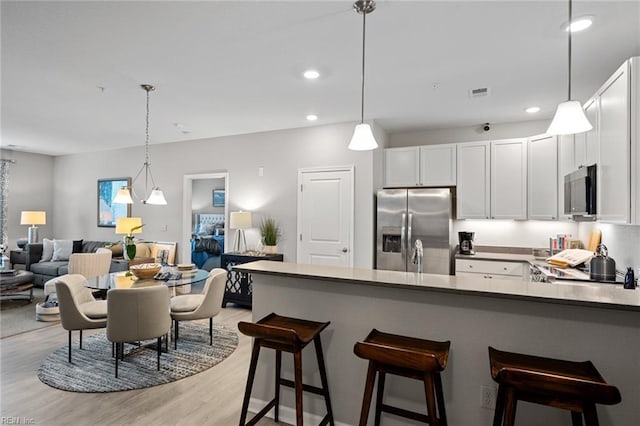 1728 Vankar Dr, Virginia Beach, VA 23456 - kitchen with appliances with stainless steel finishes, white cabinets, light wood-style flooring, and visible vents