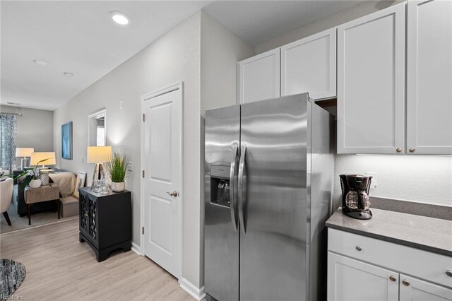 1728 Vankar Dr, Virginia Beach, VA 23456 - kitchen featuring white cabinetry, open floor plan, light wood finished floors, and stainless steel fridge with ice dispenser
