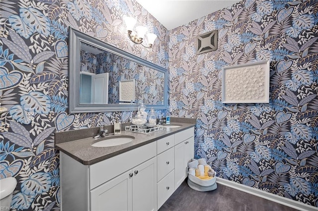 1728 Vankar Dr, Virginia Beach, VA 23456 - bathroom with a sink, baseboards, wallpapered walls, and wood finished floors