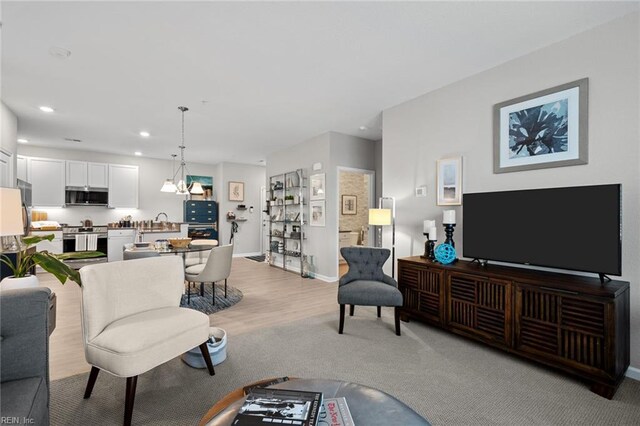 1728 Vankar Dr, Virginia Beach, VA 23456 - living room with an inviting chandelier, baseboards, recessed lighting, and light wood-style flooring