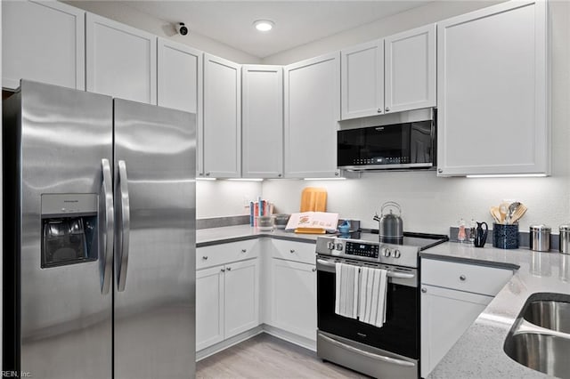 1728 Vankar Dr, Virginia Beach, VA 23456 - kitchen with light stone counters, white cabinetry, and stainless steel appliances