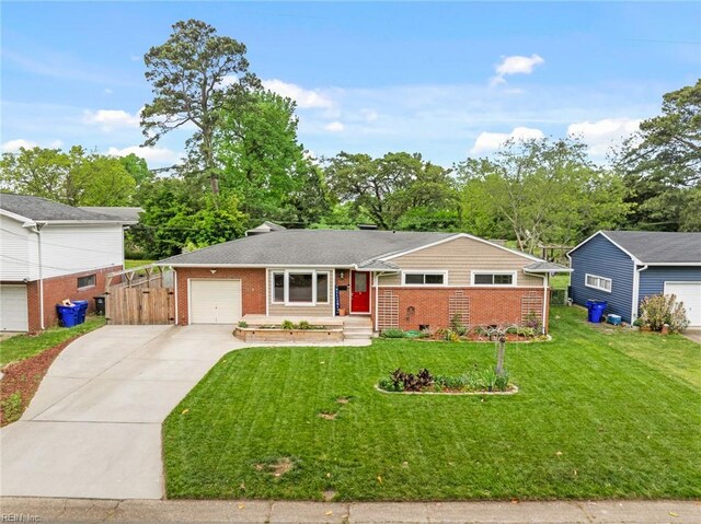 ranch-style house featuring a garage, a front yard, driveway, and brick siding