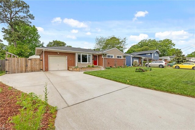 ranch-style house featuring fence, an attached garage, a front lawn, brick siding, and driveway
