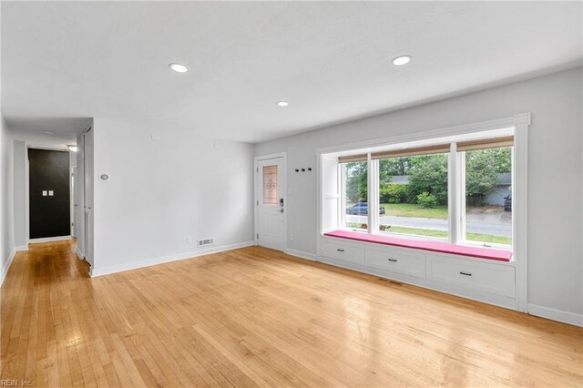 unfurnished living room featuring recessed lighting, baseboards, visible vents, and light wood-style floors