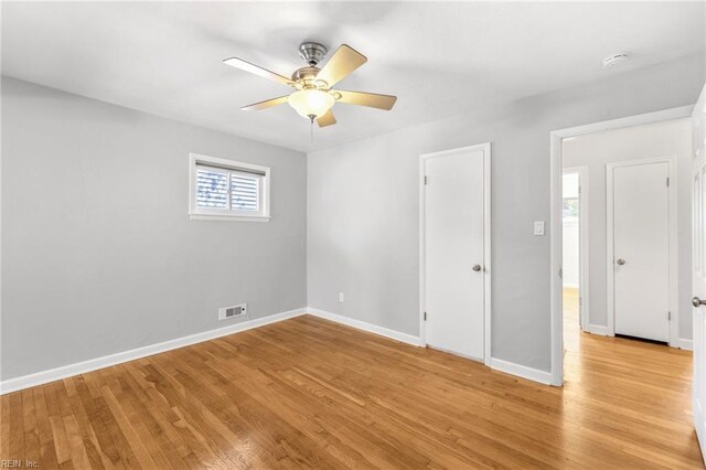 unfurnished bedroom featuring visible vents, light wood-style flooring, and baseboards