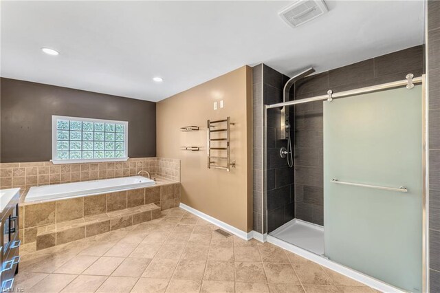 bathroom with visible vents, baseboards, a bath, tile patterned floors, and a stall shower
