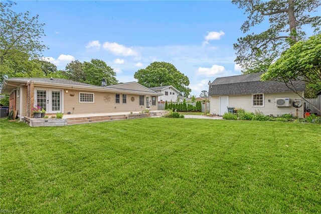 back of property featuring a yard and fence