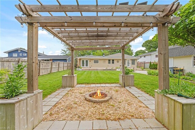 view of patio / terrace with a fenced backyard, a fire pit, and a pergola