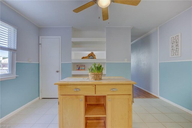 kitchen featuring baseboards, light tile patterned floors, open shelves, and ceiling fan