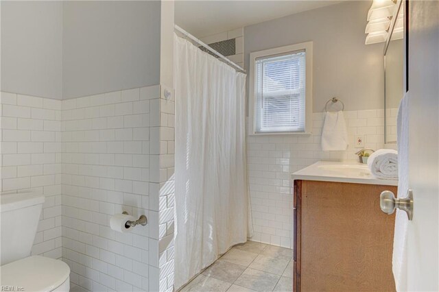 full bathroom with tile patterned flooring, vanity, toilet, tile walls, and a shower with curtain