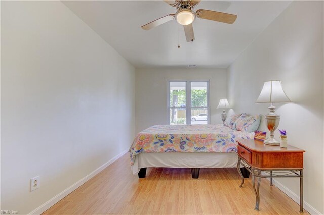 bedroom featuring baseboards, ceiling fan, and wood finished floors