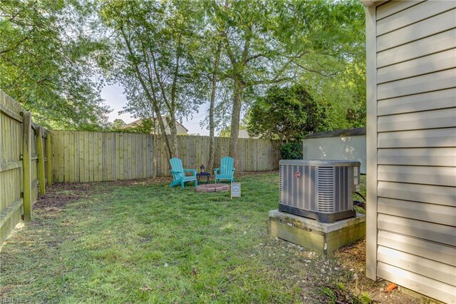 view of yard featuring a fenced backyard and central AC unit