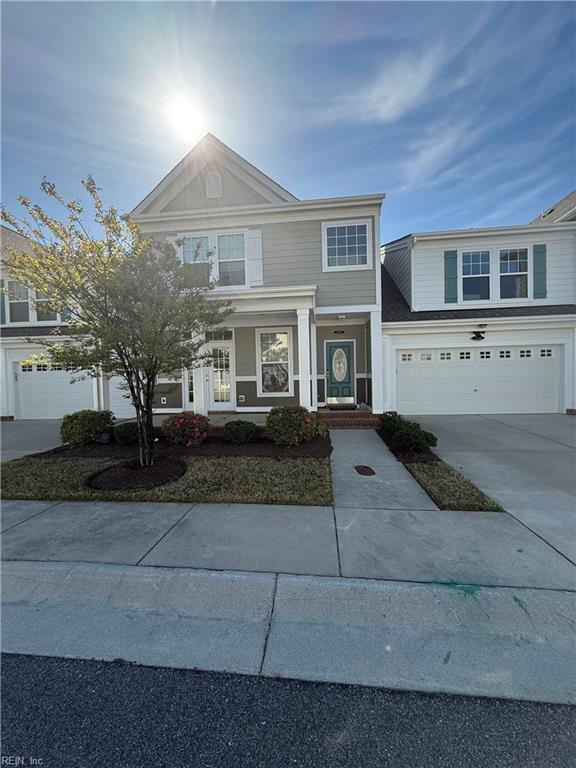 traditional-style home featuring a garage and concrete driveway