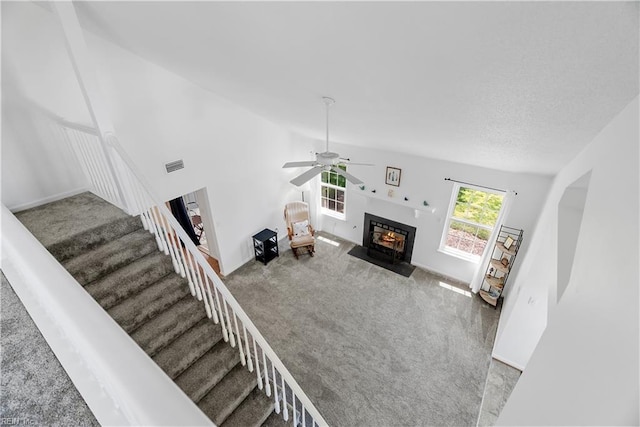 1703 Orchard Way, Chesapeake, VA 23320 - carpeted living room with ceiling fan, visible vents, a fireplace with flush hearth, stairway, and lofted ceiling