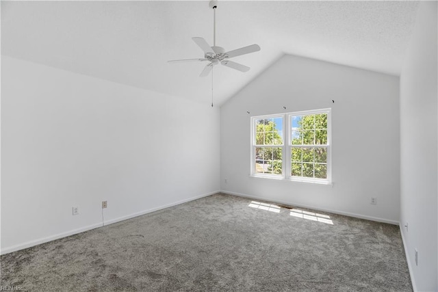 empty room with carpet floors, a ceiling fan, baseboards, and vaulted ceiling