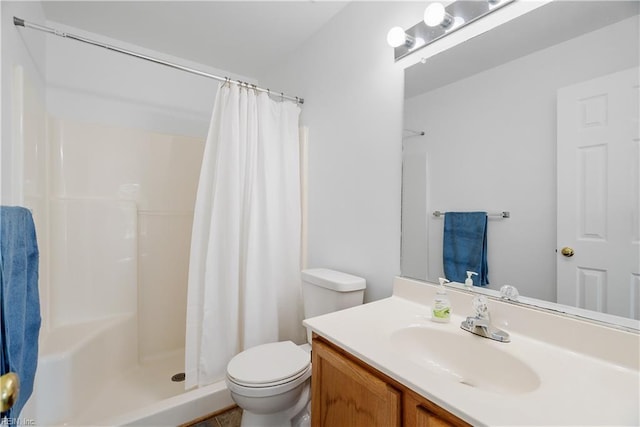 bathroom featuring vanity, a stall shower, and toilet
