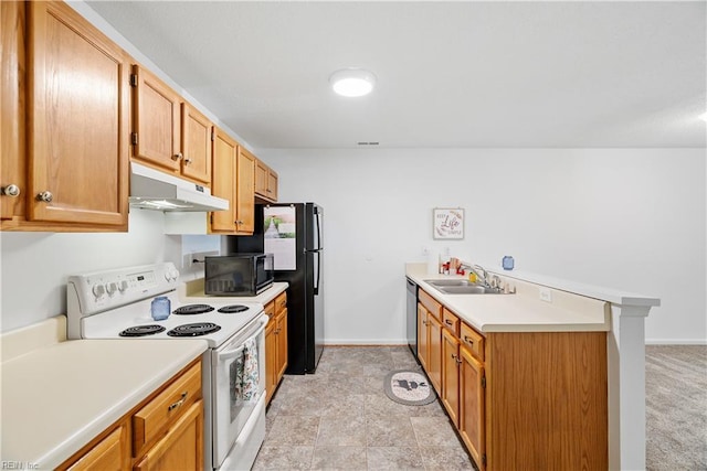 kitchen with a sink, light countertops, a peninsula, under cabinet range hood, and black appliances