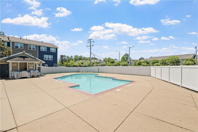 view of swimming pool featuring a patio, fence, and a fenced in pool