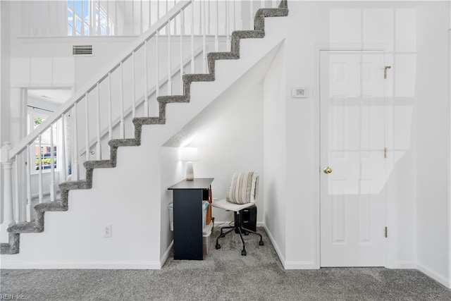 stairway featuring baseboards, carpet flooring, and visible vents