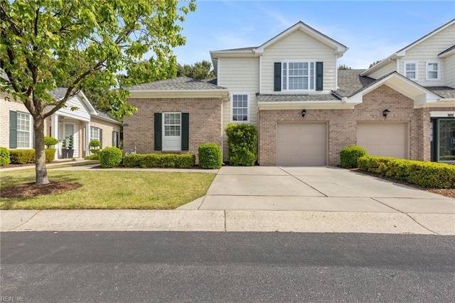traditional home featuring a garage, a front yard, roof with shingles, brick siding, and driveway