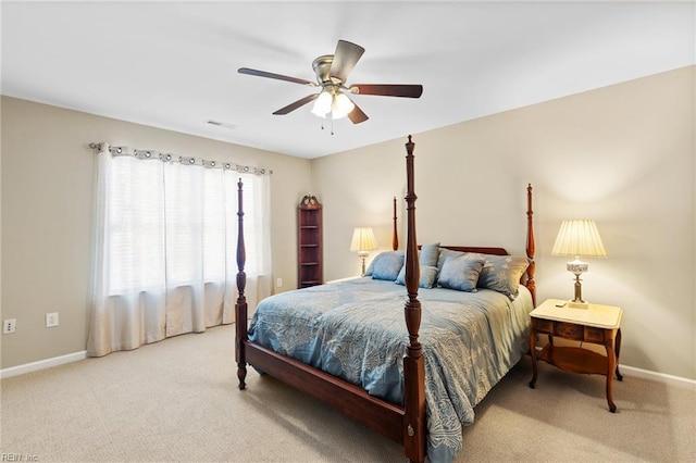 carpeted bedroom featuring a ceiling fan, baseboards, and visible vents
