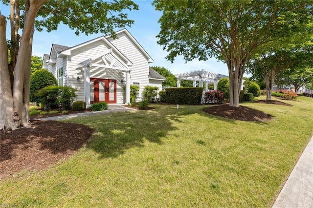 view of front of home with french doors, a pergola, and a front yard