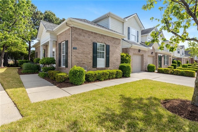 view of front of home with concrete driveway, brick siding, a front yard, and a garage