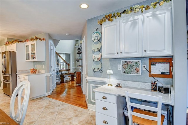 bar featuring stairway, freestanding refrigerator, recessed lighting, and light tile patterned flooring
