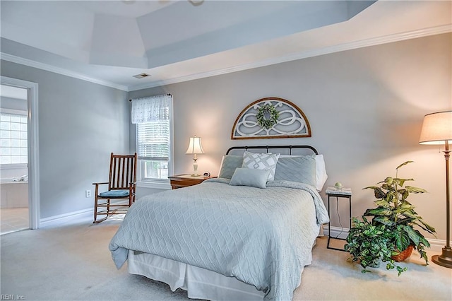 bedroom with baseboards, carpet flooring, a tray ceiling, and multiple windows