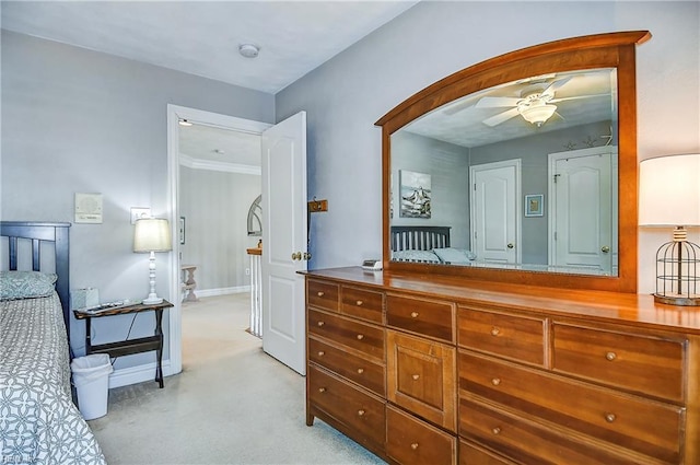 bedroom featuring light colored carpet and baseboards