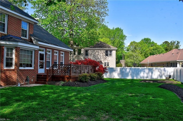 view of yard with fence and a deck