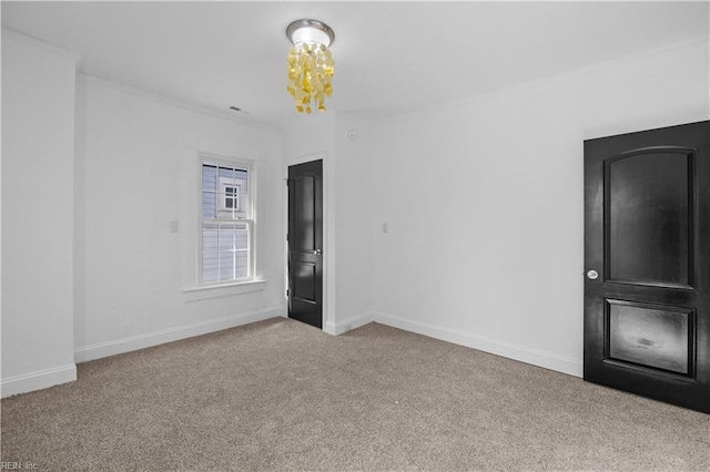 1125 Stewart St, Chesapeake, VA 23324 - carpeted spare room featuring crown molding, baseboards, and an inviting chandelier