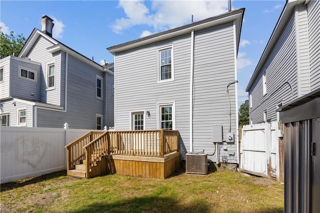 1125 Stewart St, Chesapeake, VA 23324 - rear view of property with a wooden deck, a fenced backyard, a gate, central AC unit, and a yard