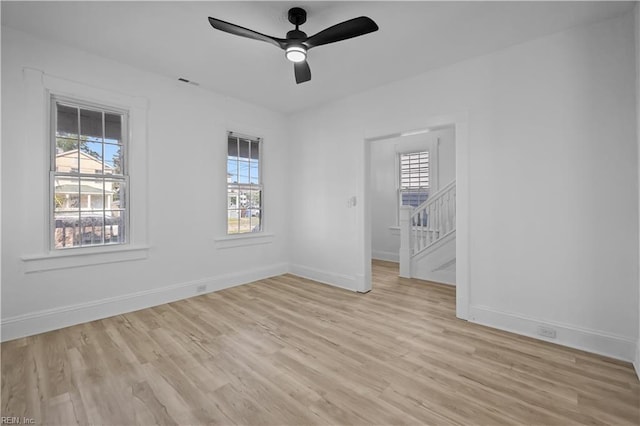 1125 Stewart St, Chesapeake, VA 23324 - unfurnished bedroom with baseboards, multiple windows, and light wood finished floors