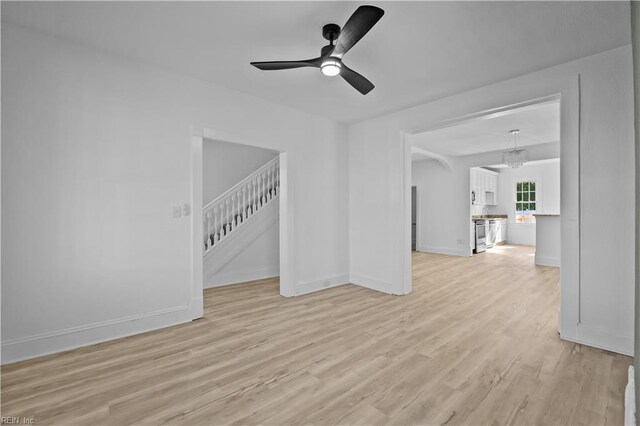 1125 Stewart St, Chesapeake, VA 23324 - unfurnished living room featuring baseboards, ceiling fan, light wood-type flooring, and stairs
